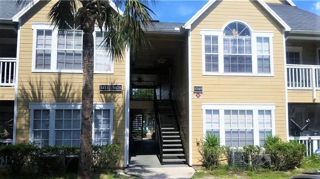 1049 South Hiawassee Road, Unit 3416 Orlando, FL 32835 - Photo 1 of 20 a view of a brick building next to a yard