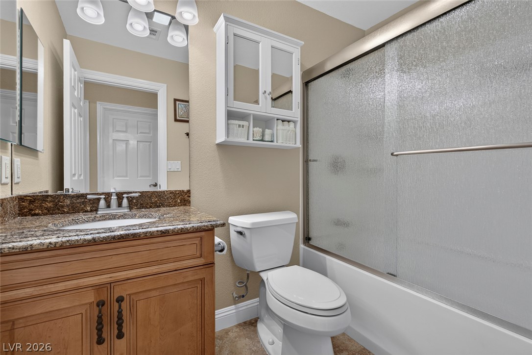 818 Manor Shores Road Henderson, NV 89002 - Photo 23 of 35 Granite counters and a convenient shower-tub combination define this well-appointed bathroom.