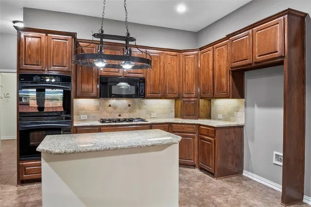a bathroom with a granite countertop sink a mirror and a bathtub