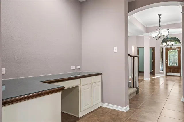 a view of an empty room with tv and a bathroom