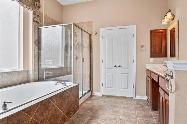 a bathroom with a sink toilet vanity and tub