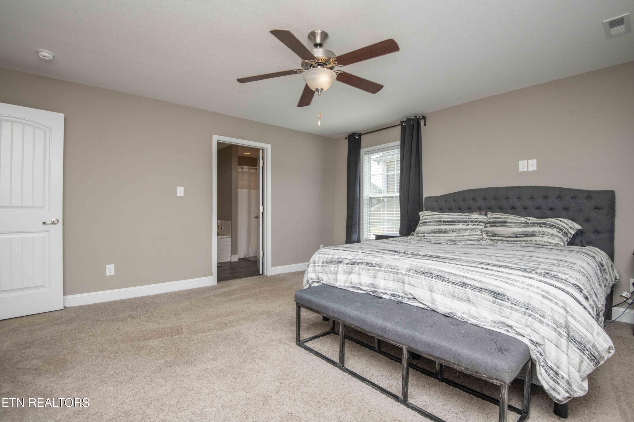 3035 Crosswinds Lane Sevierville, TN 37876 - Photo 24 of 51 a bedroom with a large bed and a ceiling fan