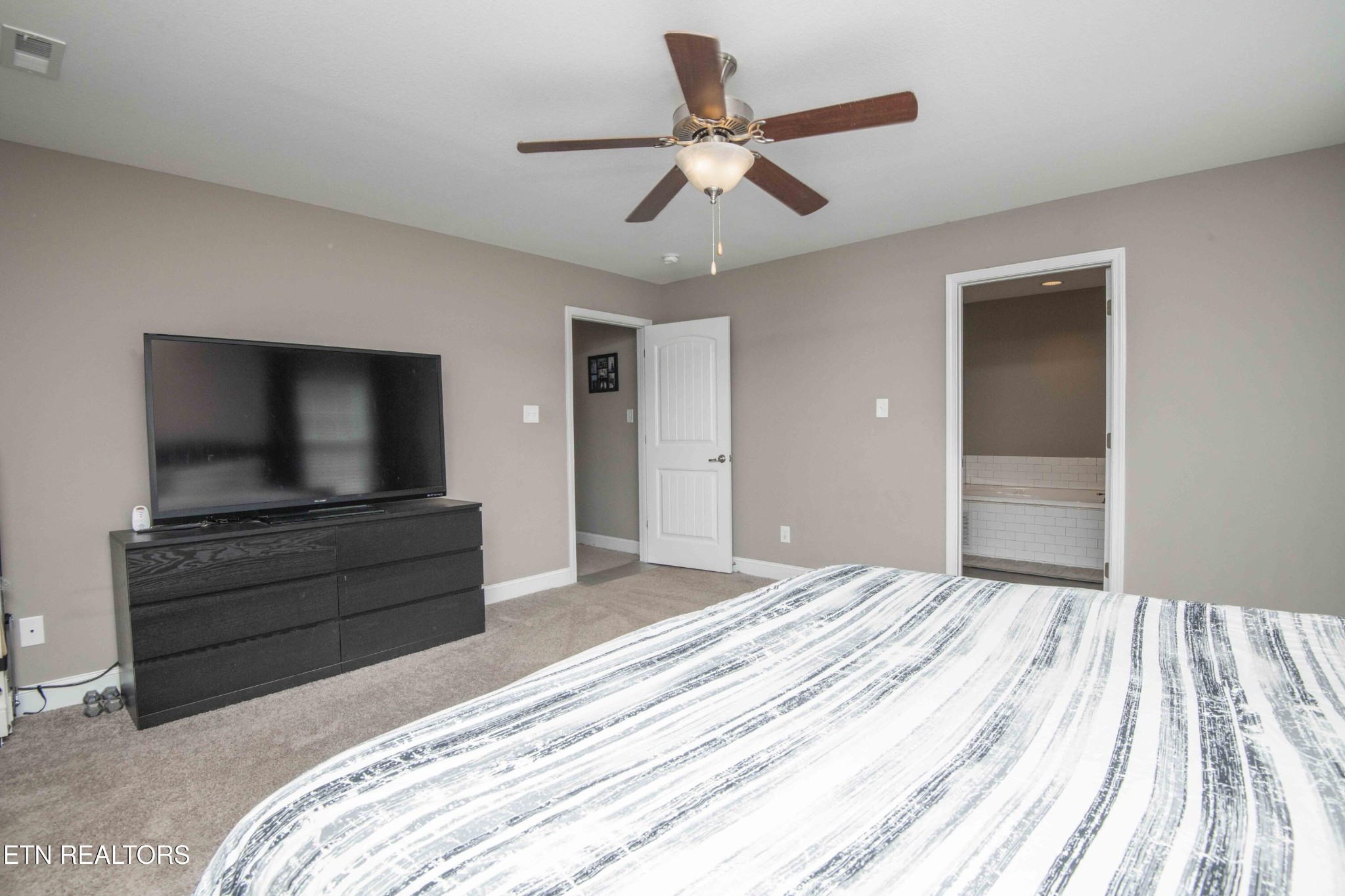3035 Crosswinds Lane Sevierville, TN 37876 - Photo 25 of 51 a bedroom with a bed and a flat screen tv