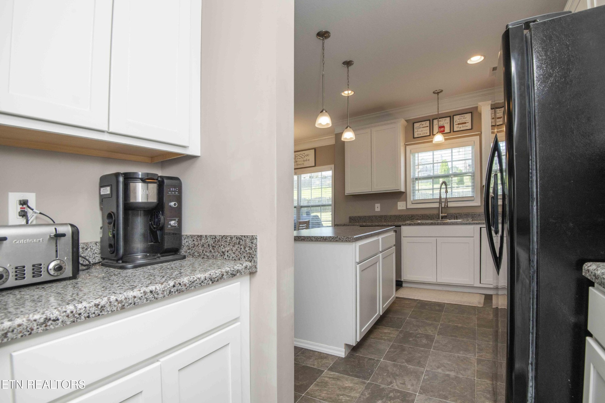 3035 Crosswinds Lane Sevierville, TN 37876 - Photo 8 of 51 a kitchen with granite countertop kitchen island white cabinets and stainless steel appliances