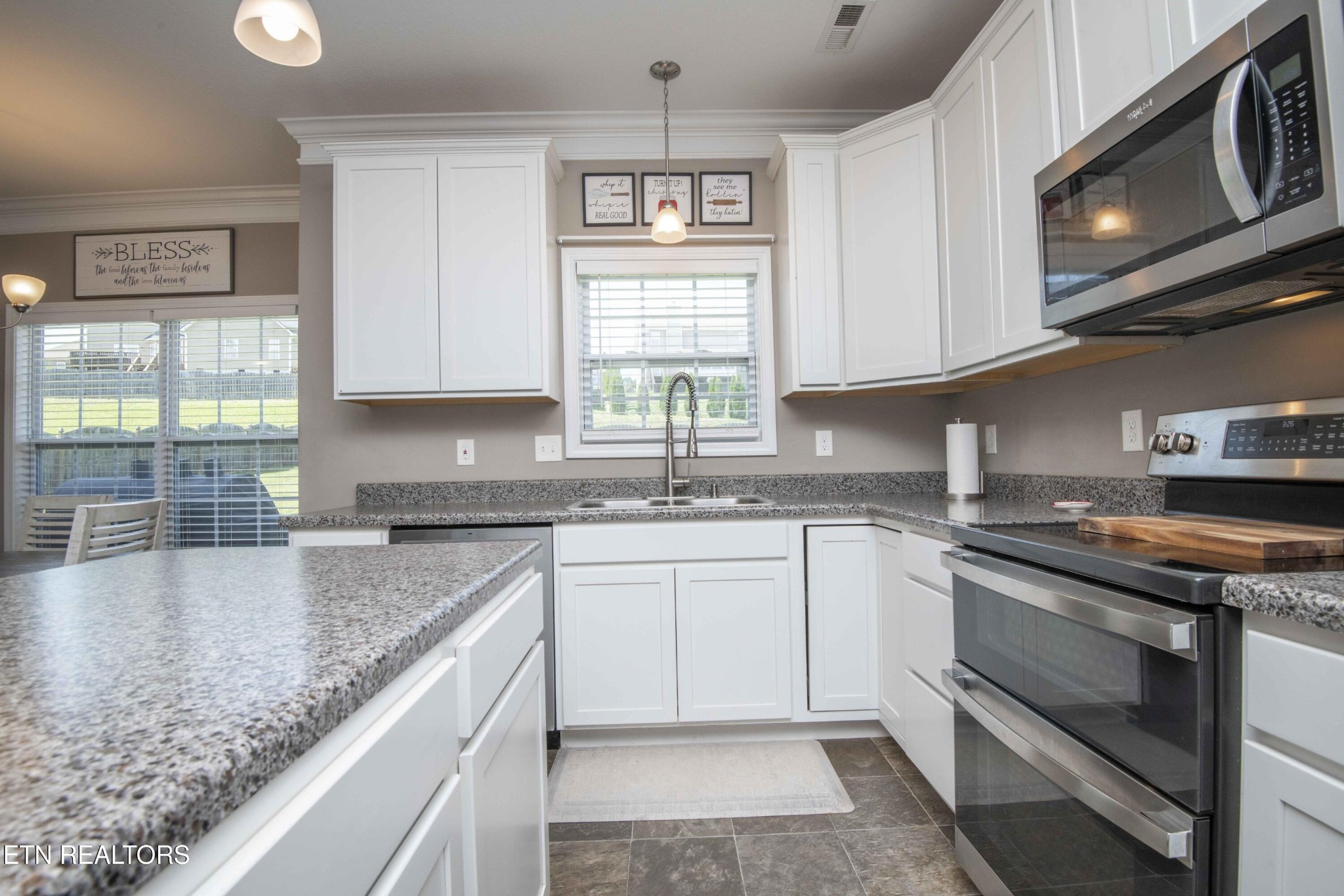 3035 Crosswinds Lane Sevierville, TN 37876 - Photo 9 of 51 a kitchen with stainless steel appliances granite countertop a sink and a stove