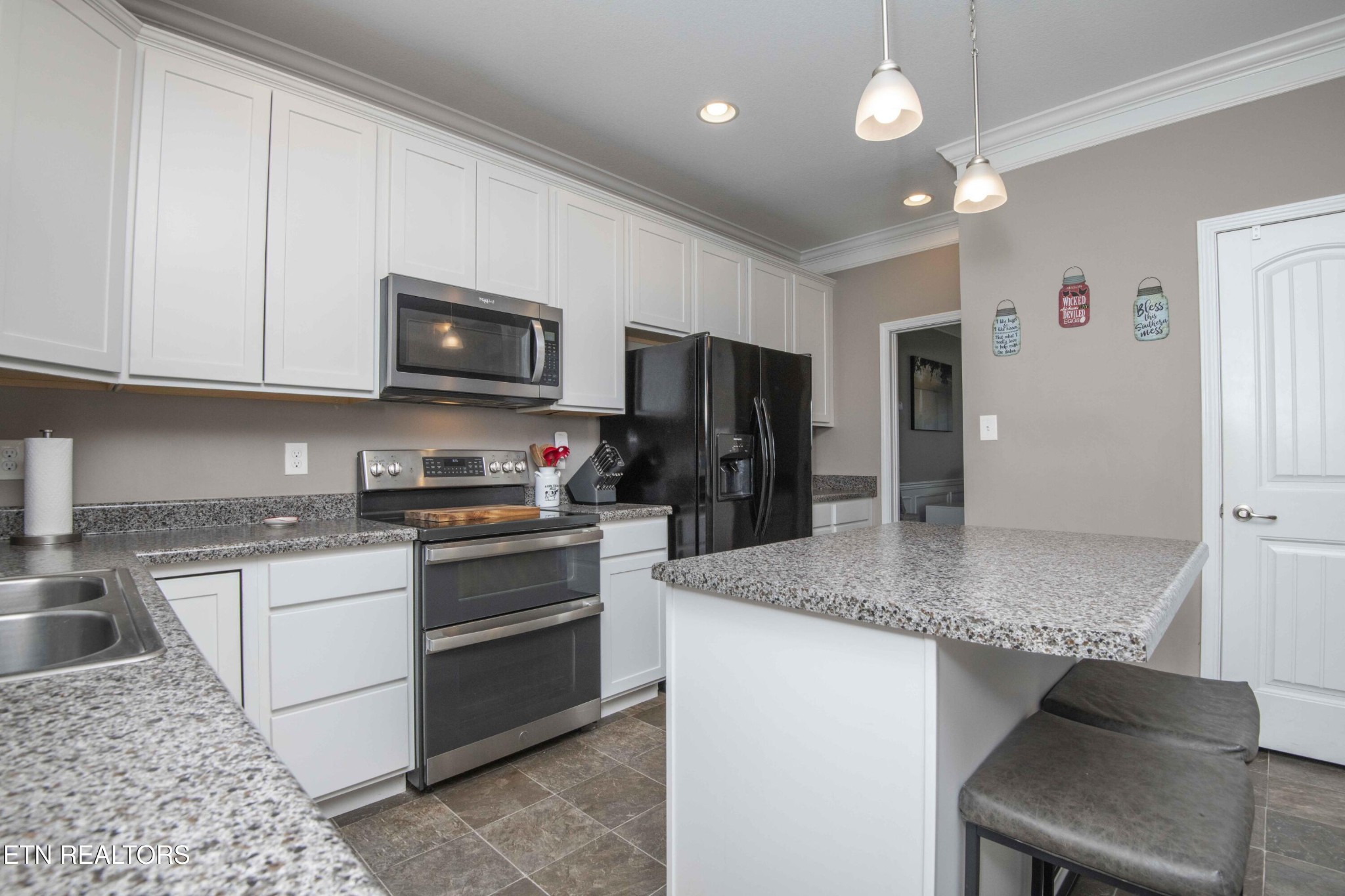 3035 Crosswinds Lane Sevierville, TN 37876 - Photo 10 of 51 a kitchen with stainless steel appliances granite countertop a sink stove and refrigerator