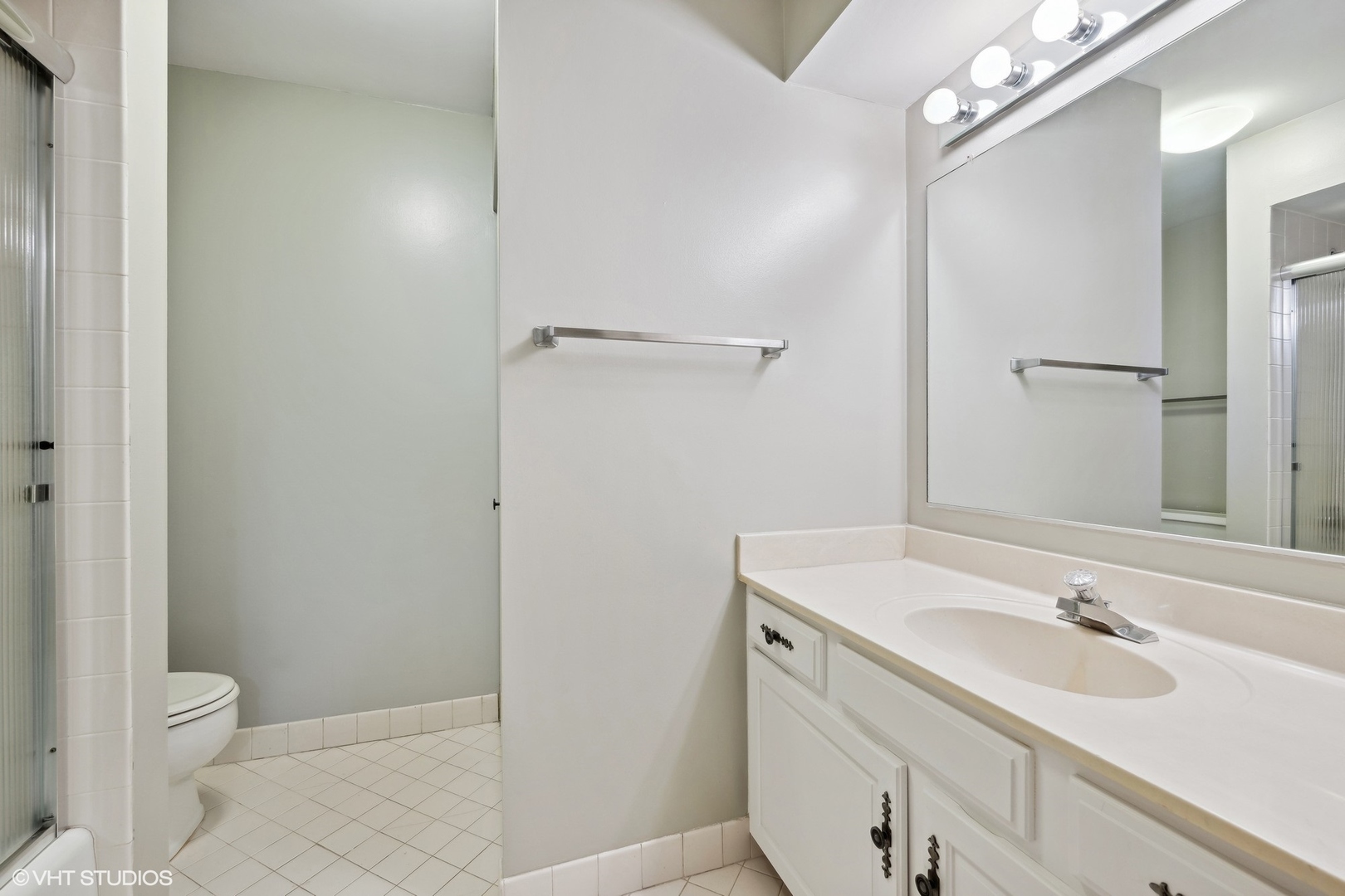 3851 Mission Hills Road, Unit 203 Northbrook, IL 60062 - Photo 14 of 21 a bathroom with a sink toilet and shower