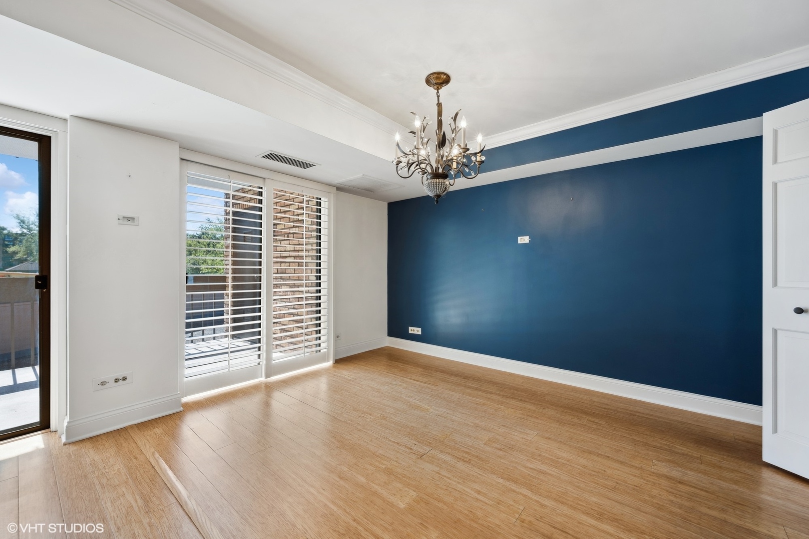 3851 Mission Hills Road, Unit 203 Northbrook, IL 60062 - Photo 8 of 21 a view of an empty room with wooden floor and a window