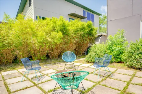 a backyard of a house with table and chairs