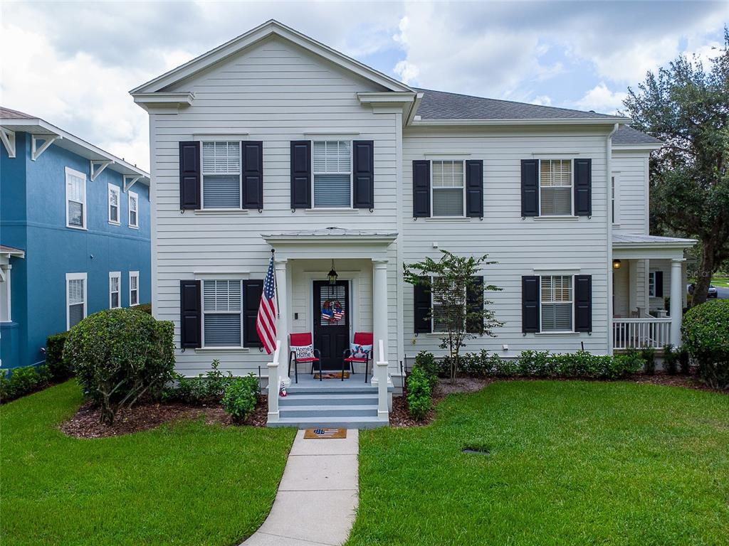 a front view of a house with a garden and plants