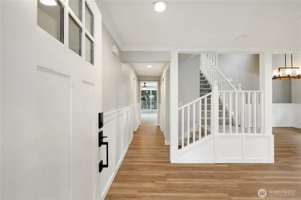 a view of an empty room window and wooden floor