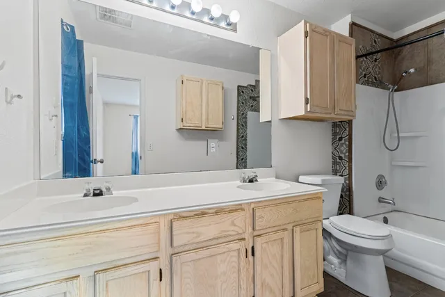 a bathroom with a shower a toilet and sink