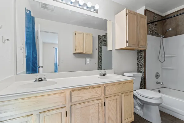 a bathroom with a shower a toilet and sink