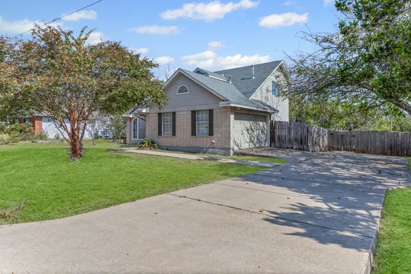 a front view of house with yard and green space