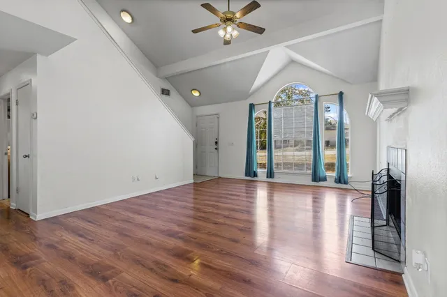 a view of a kitchen with microwave and windows