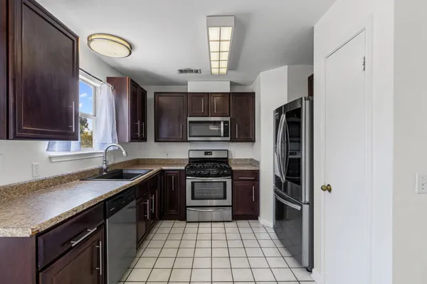 a kitchen with a sink stove and microwave