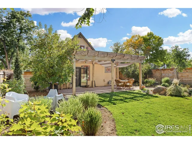 a view of a patio with table and chairs and potted plants