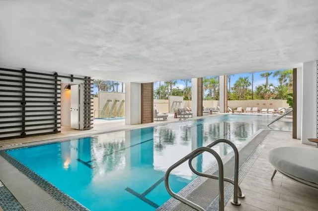 an aerial view of multi story residential apartment building with yard