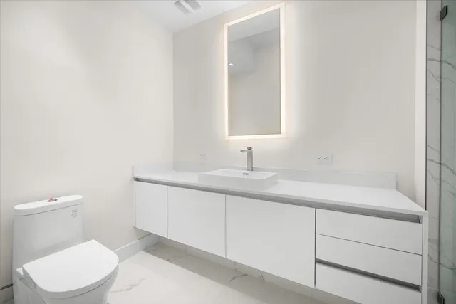 a bathroom with a double vanity sink mirror and shower