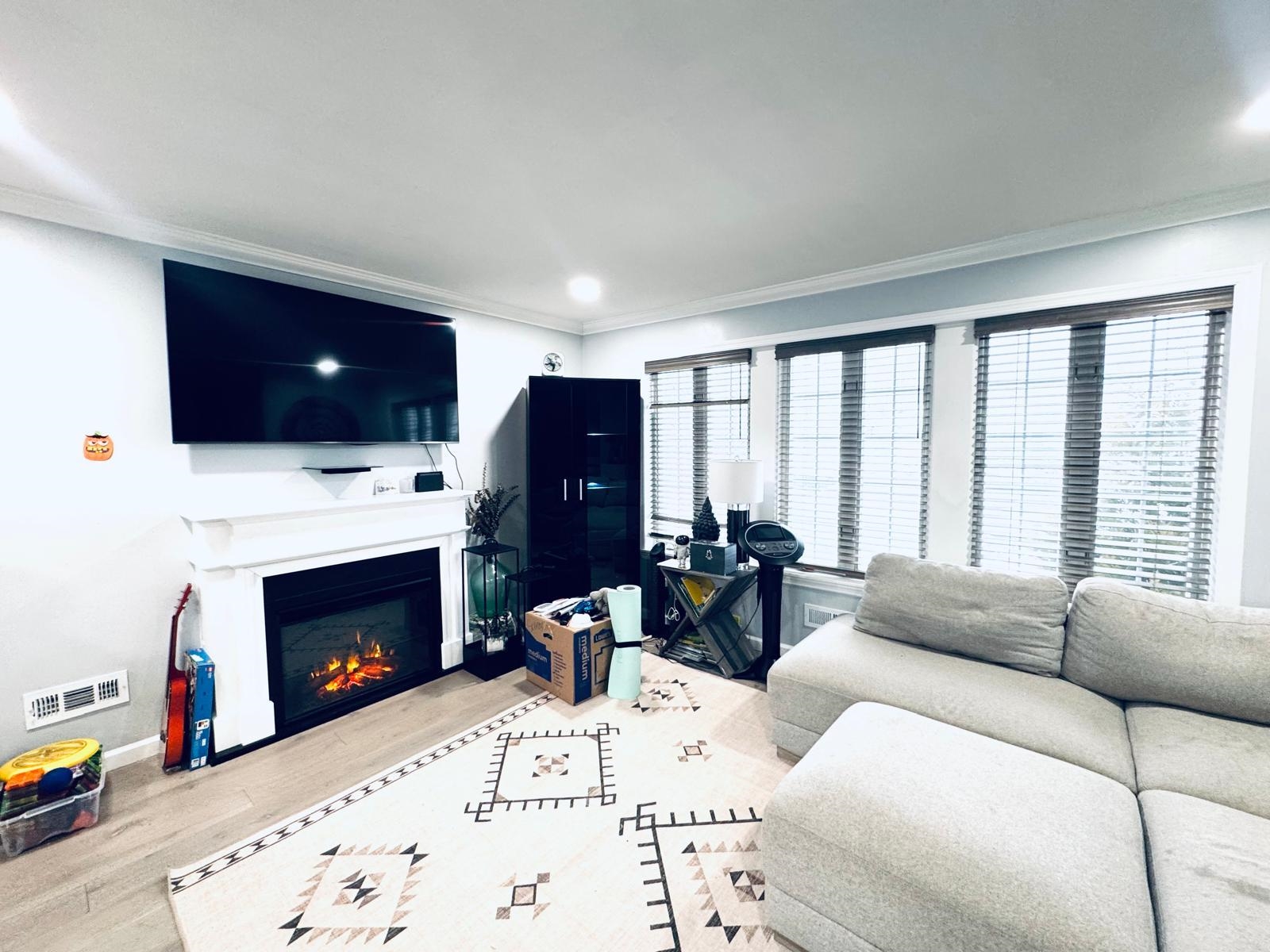 53 Harrison Street Dumont, NJ 07628 - Photo 2 of 28 a living room with furniture a fireplace and a flat screen tv