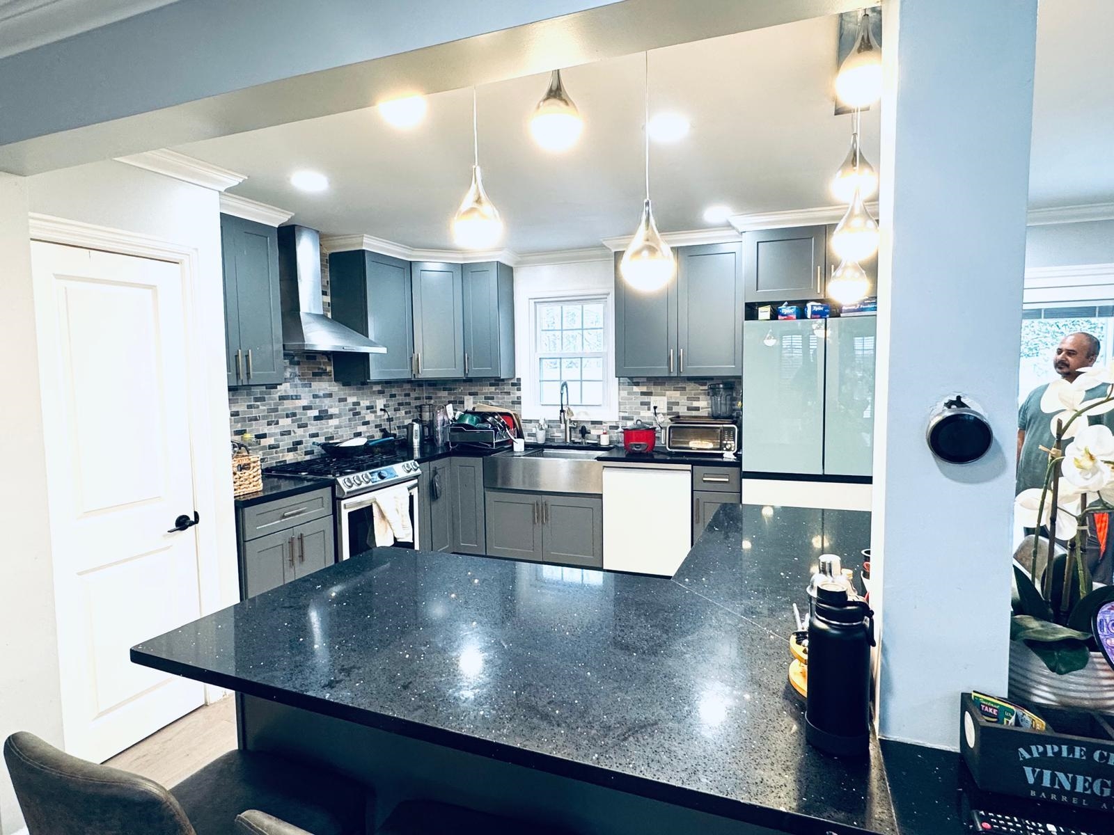 53 Harrison Street Dumont, NJ 07628 - Photo 10 of 28 a kitchen with stainless steel appliances granite countertop a sink dishwasher a stove and a refrigerator with wooden floor