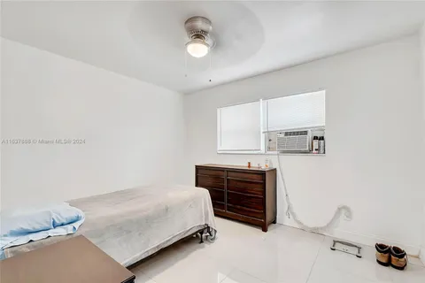 a bedroom with a bed and cabinets