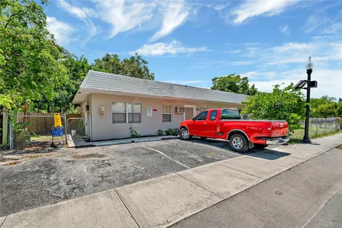 a view of a house with a cars parked in front of it