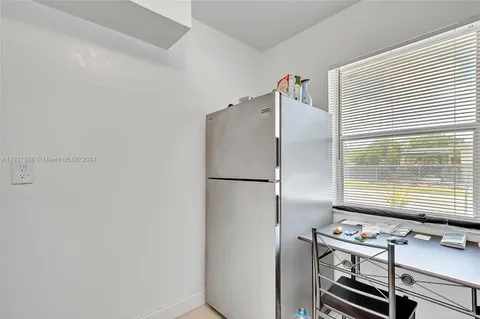 a kitchen with a refrigerator and a window