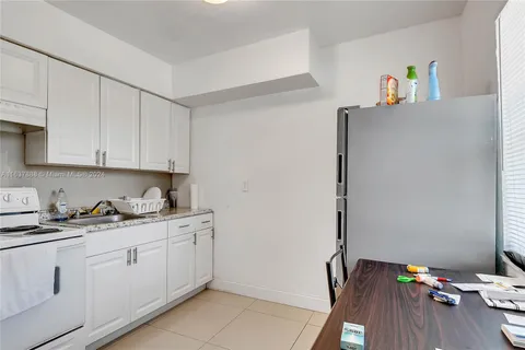 a kitchen with sink cabinets and wooden floor