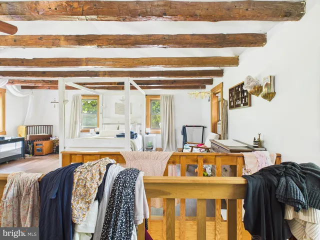 a very nice looking bedroom with furniture and a large window
