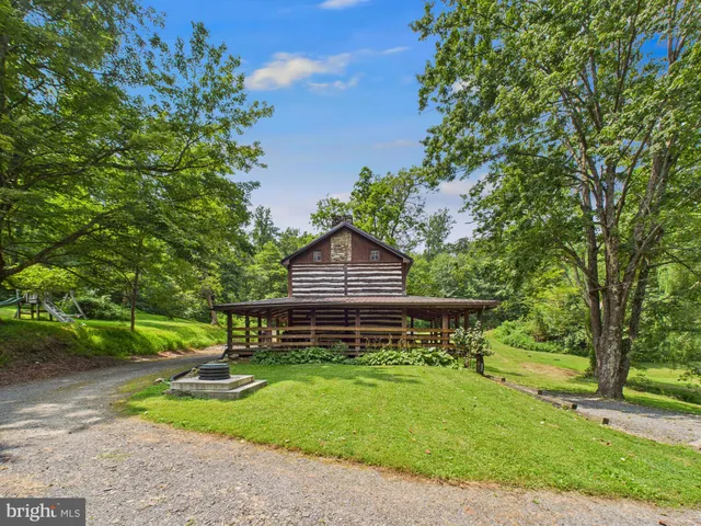 a front view of a house with a yard table and chairs