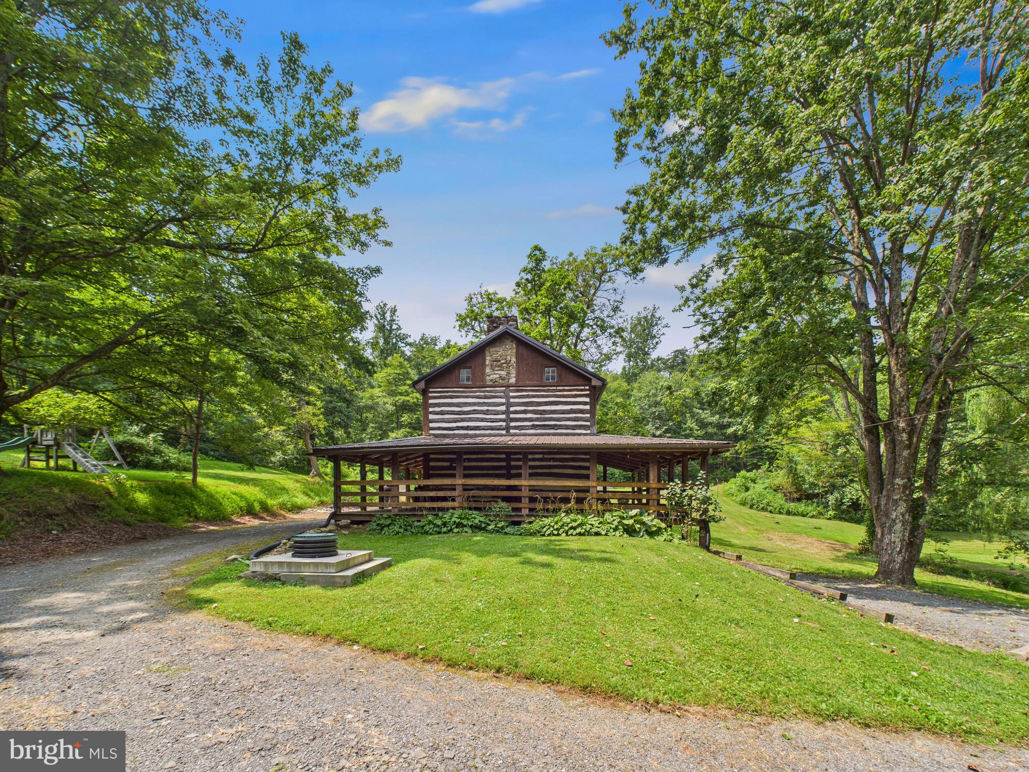 1640 Dunkleberger Road Elliottsburg, PA 17024 - Photo 5 of 39 a front view of a house with a yard table and chairs
