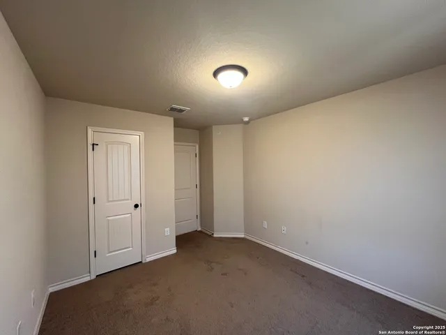 an empty room with closet area