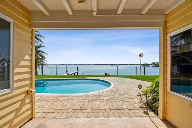 a front view of a house with a yard and potted plants