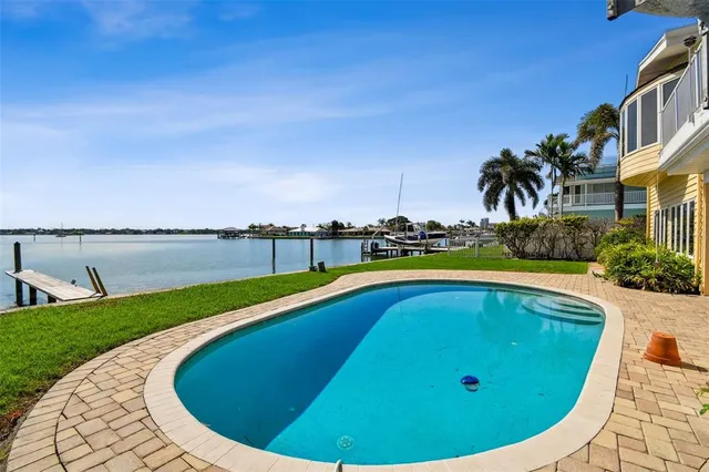 an aerial view of residential houses with outdoor space and swimming pool