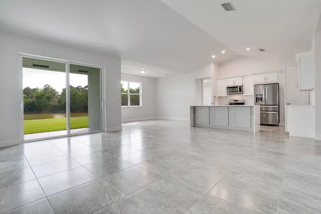 a view of an empty room with a kitchen