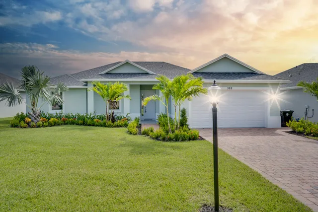 a front view of house with yard and trees