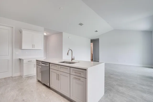a kitchen with a sink and cabinets