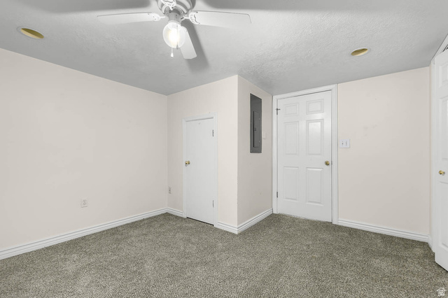 1822 East 9800th Street South Sandy, UT 84092 - Photo 19 of 38 Unfurnished bedroom with a textured ceiling, carpet floors, electric panel, and a ceiling fan