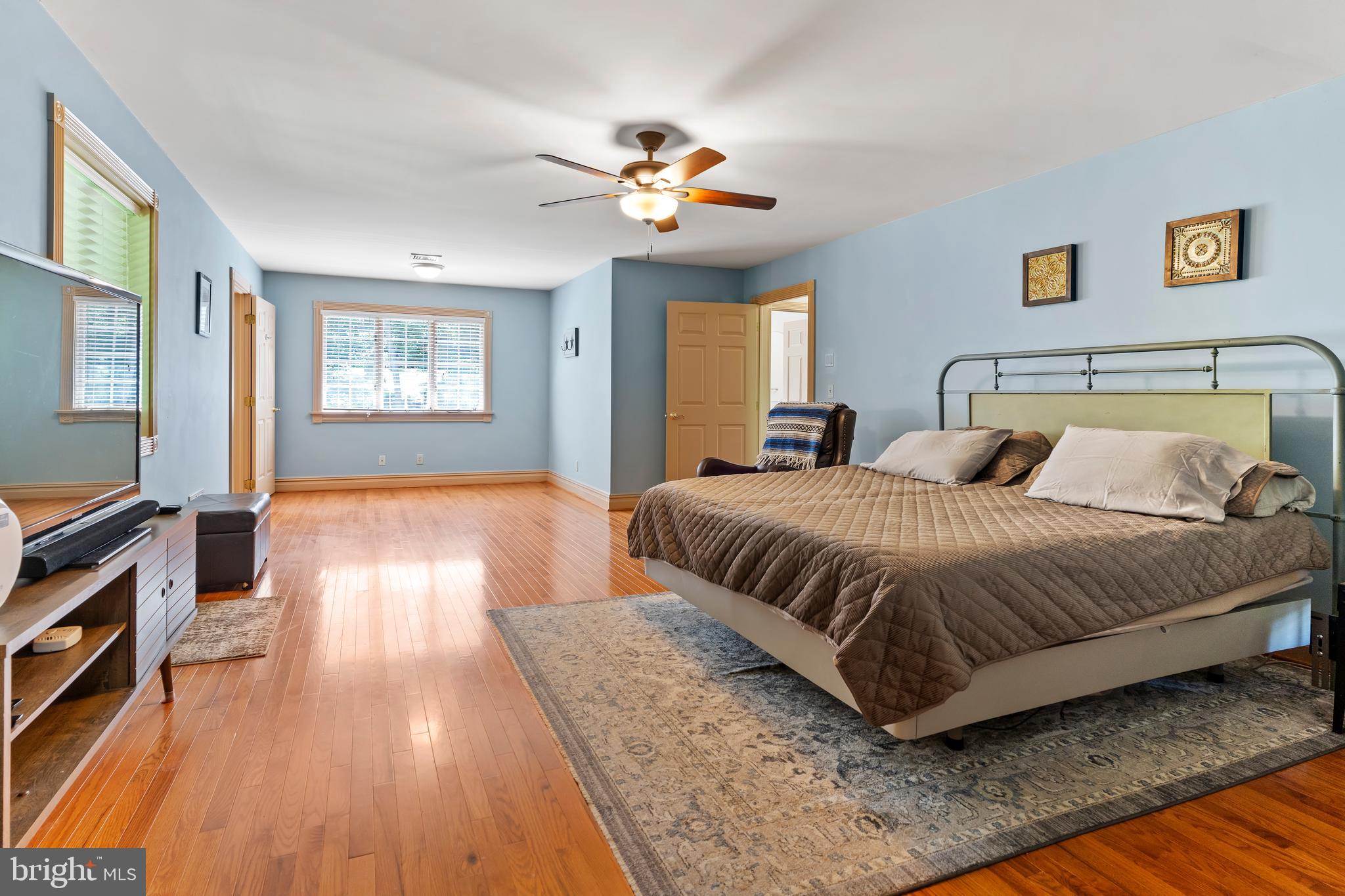 176 Richland Road Carlisle, PA 17015 - Photo 25 of 59 a spacious bedroom with a bed and a chandelier