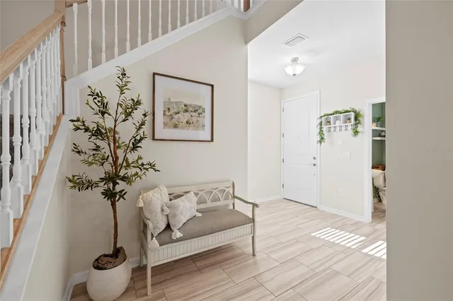 a living room with furniture and flowers