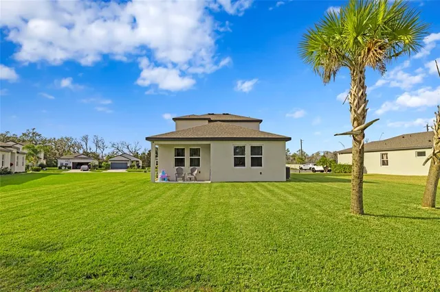 a view of a big yard with a house