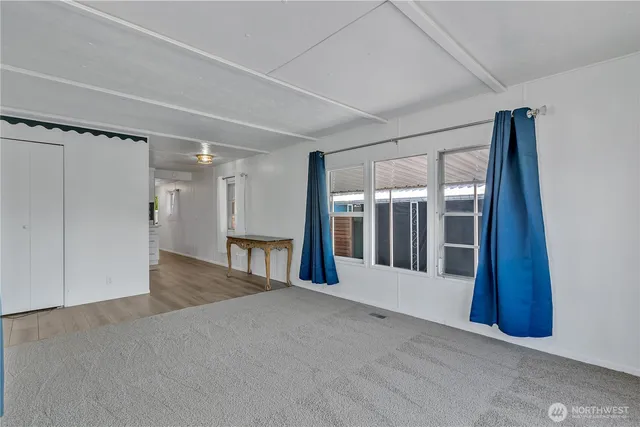 a view of a big room with a fireplace and entryway