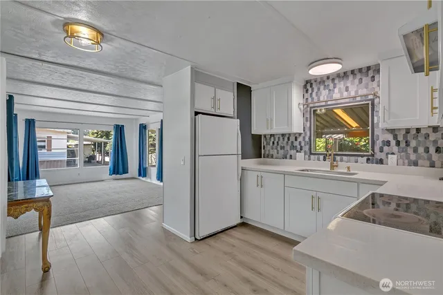 a kitchen with a refrigerator and a sink