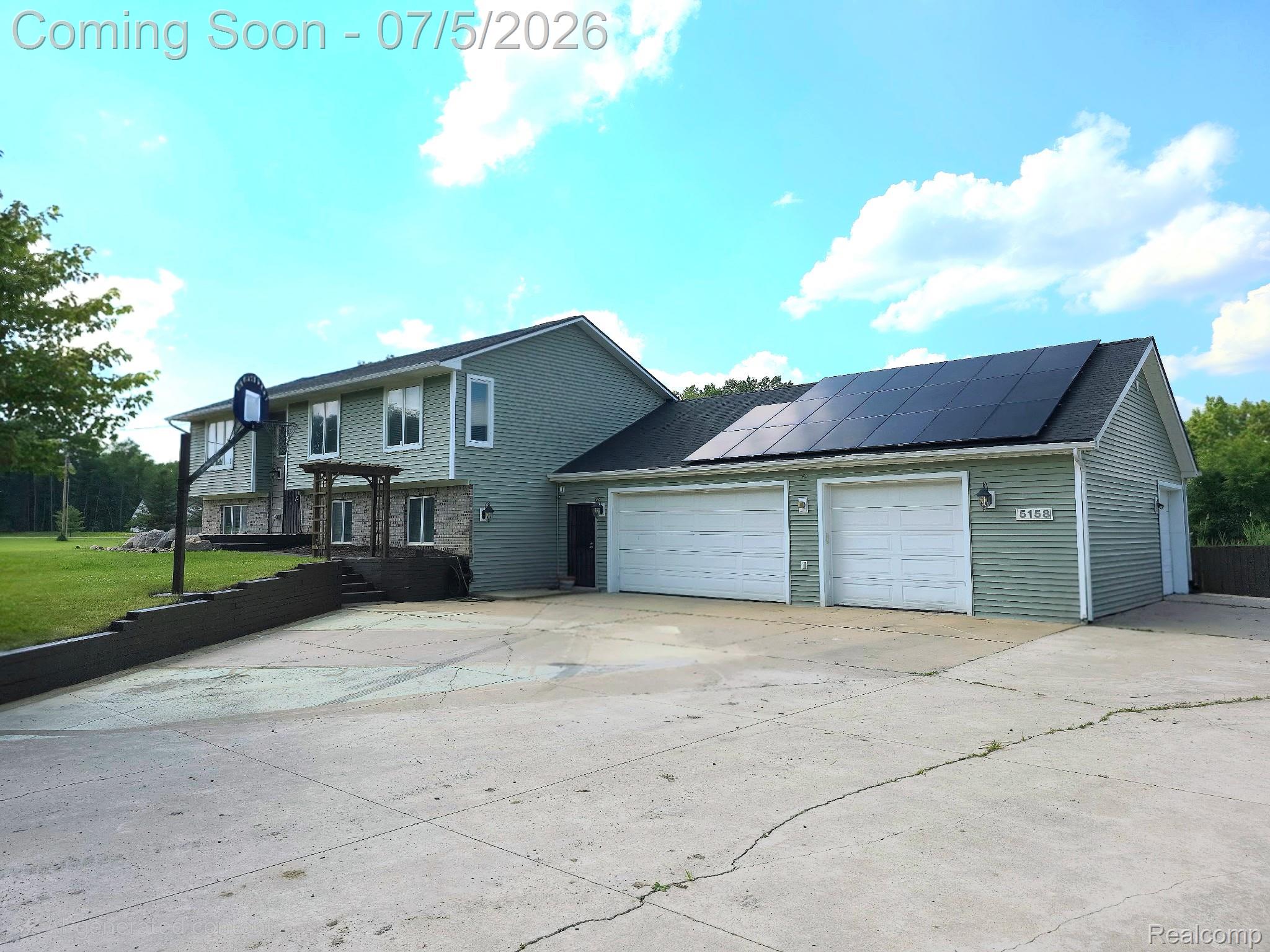 5158 Coldwater Road Columbiaville, MI 48421 - Photo 1 of 1 Two-story residence featuring light green siding and a stone facade