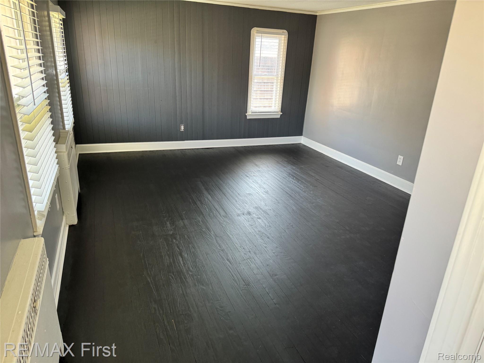 1349 Devonshire Road Grosse Pointe, MI 48230 - Photo 17 of 26 Room featuring dark wood-finish flooring, white baseboards, and a window with blinds