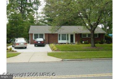 5209 Heming Avenue Springfield, VA 22151 - Photo 1 of 18 a front view of a house with a garden