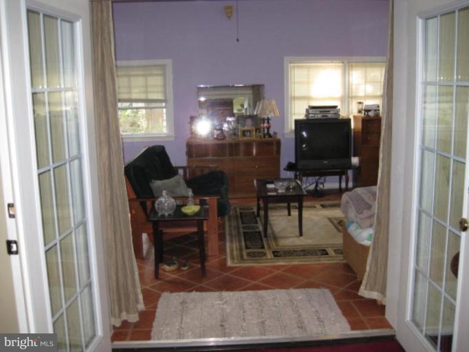 5209 Heming Avenue Springfield, VA 22151 - Photo 11 of 18 a living room with furniture a dining table and a flat screen tv