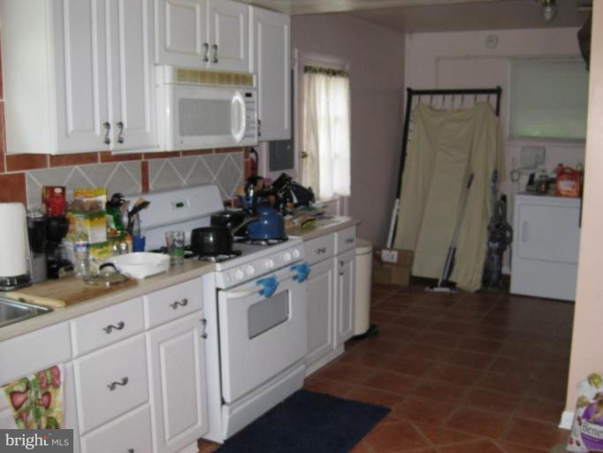 5209 Heming Avenue Springfield, VA 22151 - Photo 6 of 18 a kitchen with cabinets and window