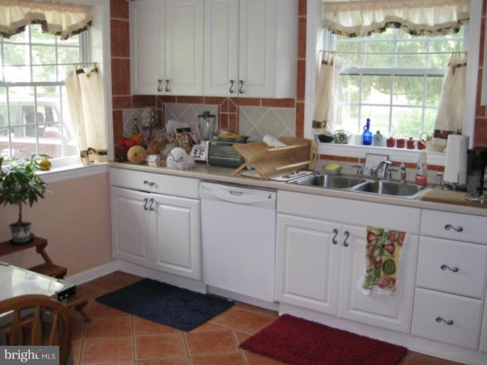 5209 Heming Avenue Springfield, VA 22151 - Photo 7 of 18 a kitchen with white cabinets and window